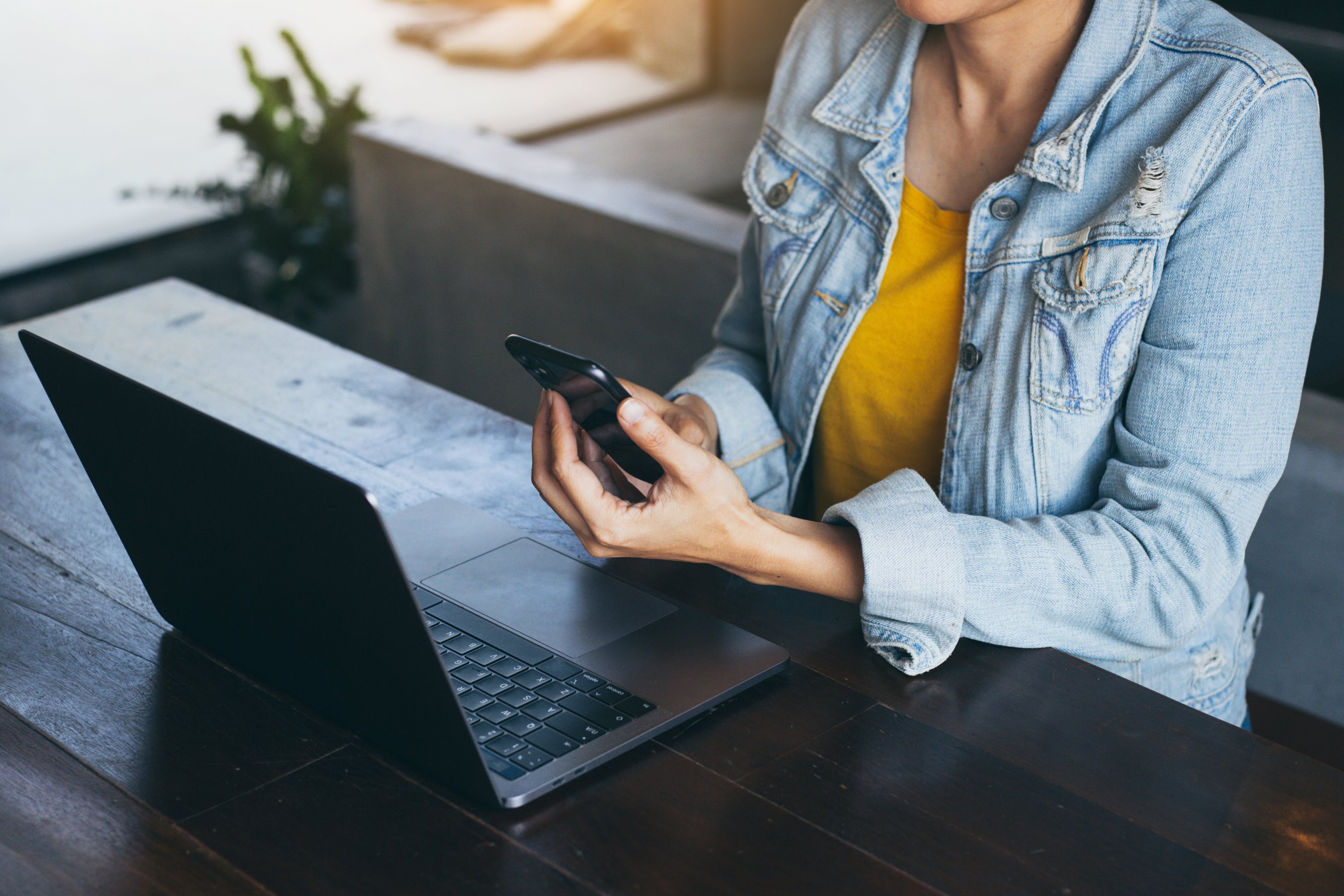 work using texting cell phone typing computer.chatting on mobile,laptop contact us at workplace Thinking investment plan Investor.searching information internet